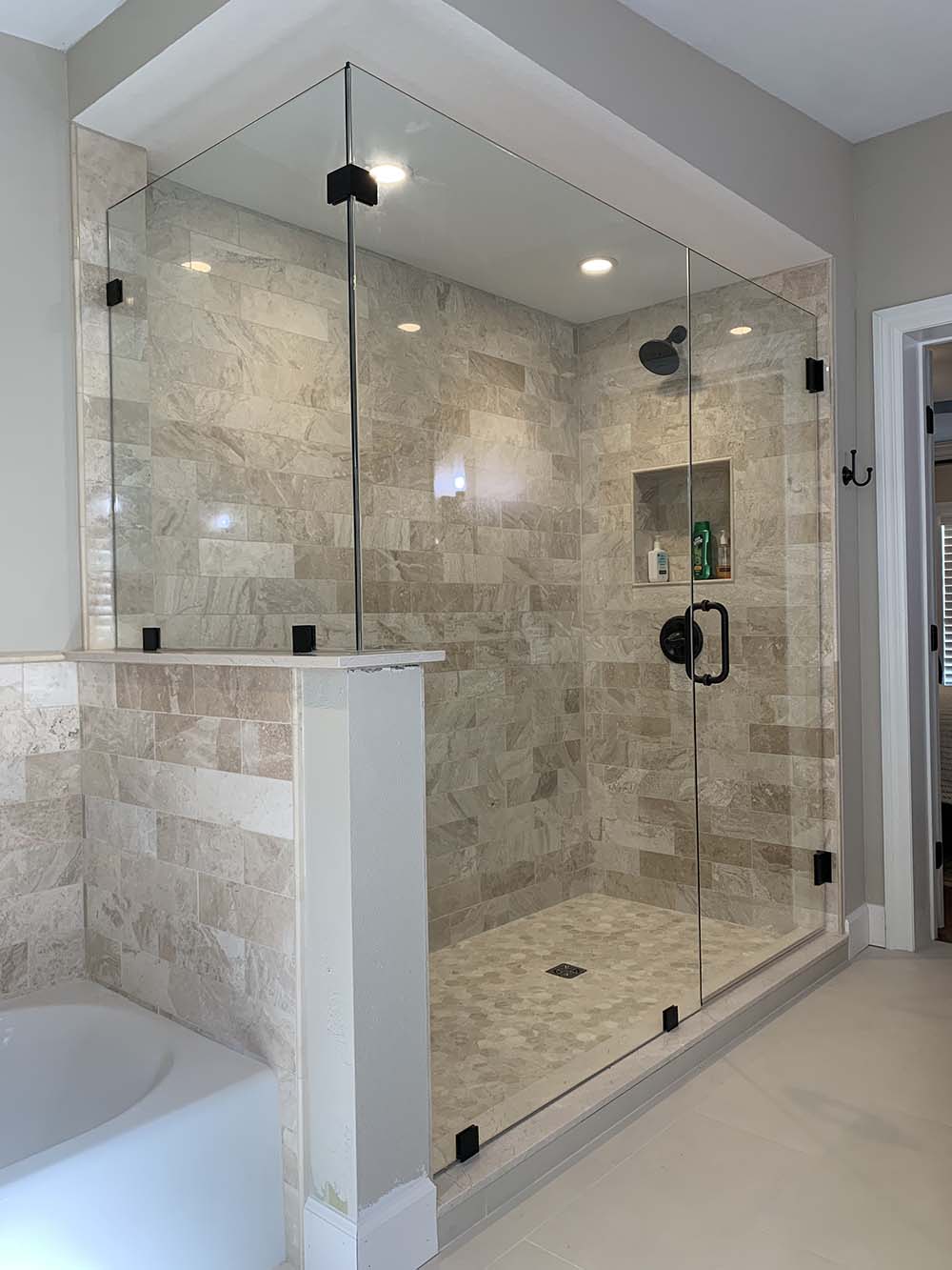 Frameless glass shower enclosure example in modern bathroom